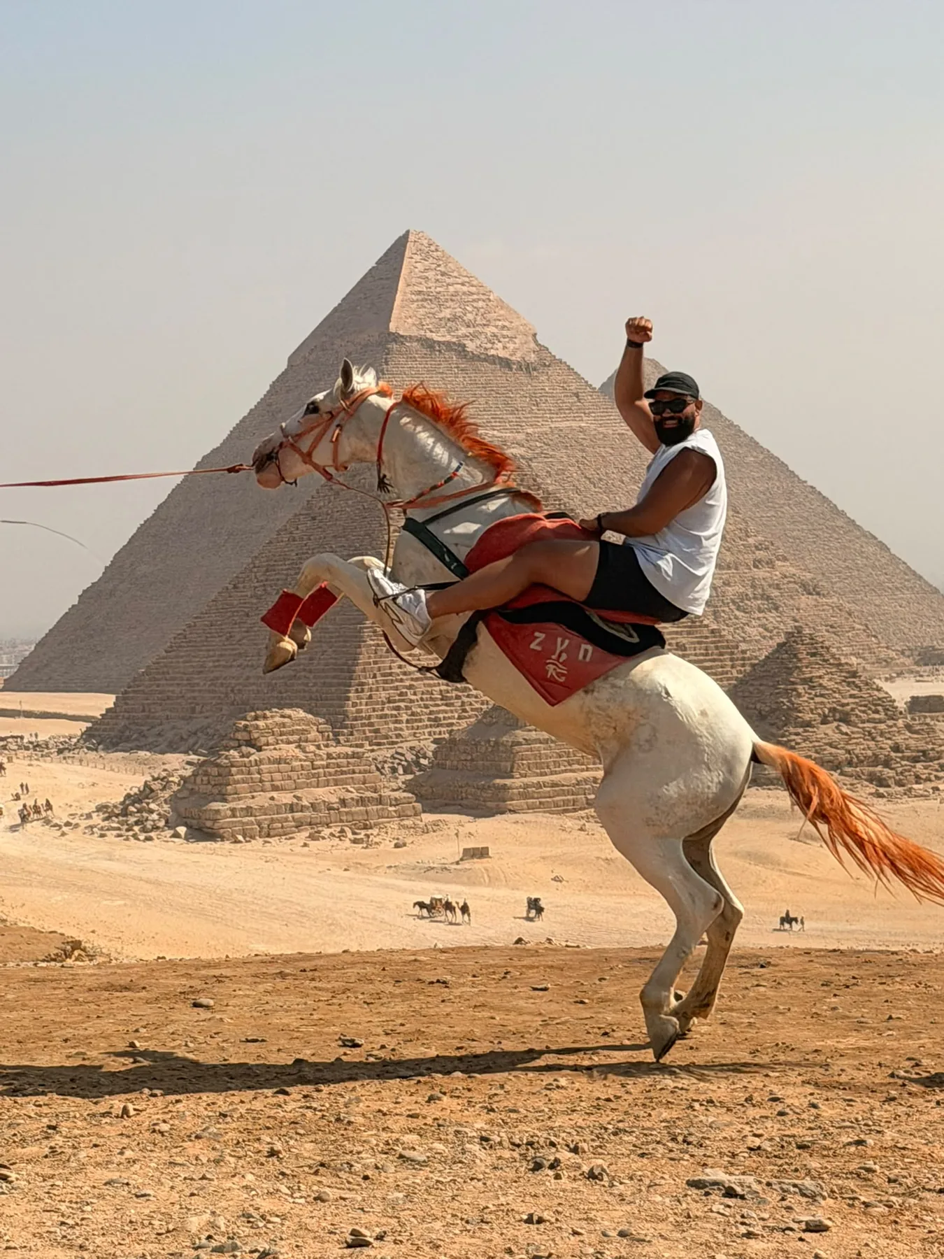 Visitor on horseback in front of the Giza Pyramids